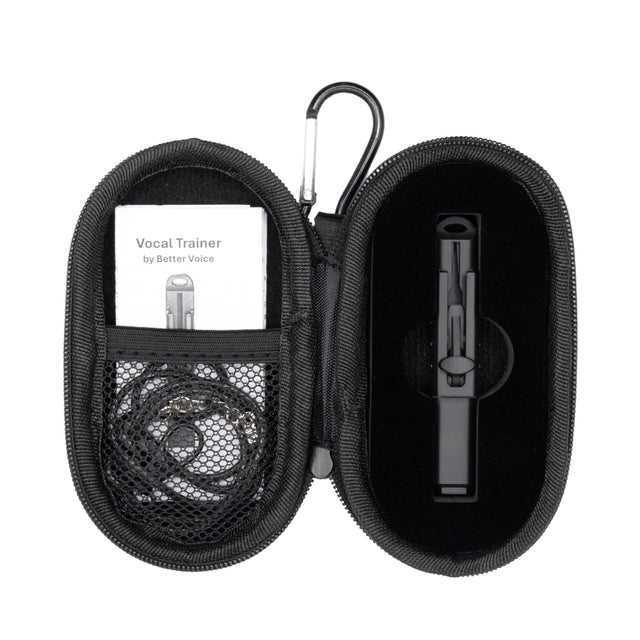 Open carrying case showing the Vocal Trainer, necklace, and instruction card.